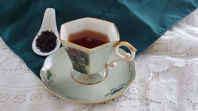 Elegant teacup of tea on a teal cloth